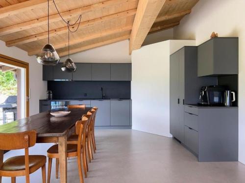 a kitchen with a wooden table and chairs at Casa Campanula - No 1 Ferienhaus in Laax in Laax