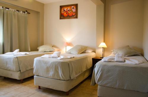 a bedroom with two beds with towels on them at Munay Salta in Salta