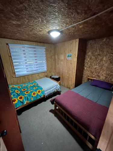 Säng eller sängar i ett rum på Cabaña los robles