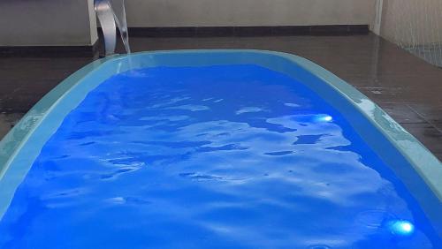 una piscina con agua azul en una habitación en Casa com Piscina na Praia, en Balneário Barra do Sul