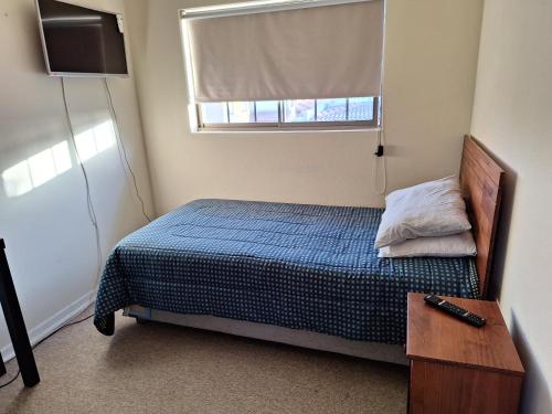 Un pat sau paturi într-o cameră la Hospedaje casa Arrayan
