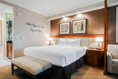 ein Hotelzimmer mit einem großen Bett und einem Stuhl in der Unterkunft Signature Rental by Owner Direct in Las Vegas