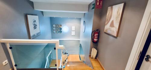 einen Flur mit blauen Wänden und eine Treppe mit blauen Decken in der Unterkunft Hostel 165 in Madrid