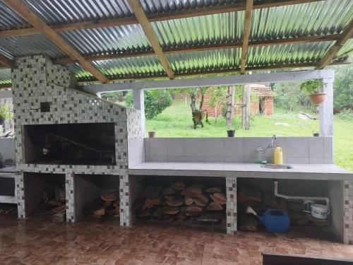 a outdoor oven with a pile of wood at Cabaña Los Nietitos in Tranqueras