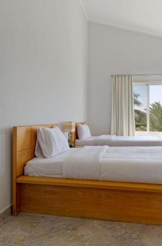 Ένα ή περισσότερα κρεβάτια σε δωμάτιο στο White Villa with open lagoon view