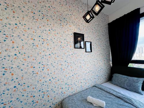 a bedroom with a bed and a wall with flowers at New 2BR or 3BR Homey Getaway stay 7 to 10 pax at Urban Suites, Georgetown by URBAN STAYCATION LOD in Jelutong