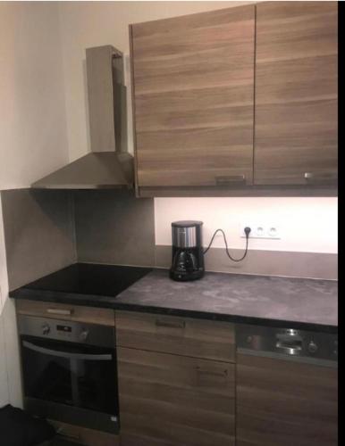a kitchen with a coffee maker on a counter at Pavillon 1 à 4 personnes chez l’habitant parfait pour une famille in Bagneux