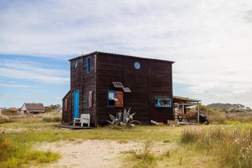a small house sitting on top of a field at Satori in Barra de Valizas