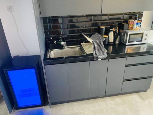 a kitchen with a sink and a microwave at Lovely flat in Tel Aviv 32 in Tel Aviv