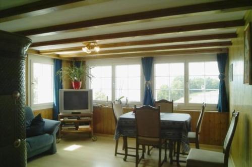 a living room with a table and a tv at Ferienwohnung, Ferienhof Wald - b48545 in Goldingen