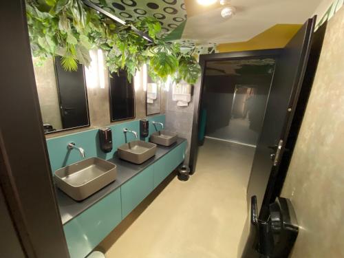 a bathroom with three sinks and two mirrors at Apartment Snow & Spa Czarna Góra Resort in Sienna