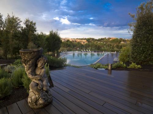 a wooden deck with a large pool of water at A.Roma Lifestyle Hotel in Rome