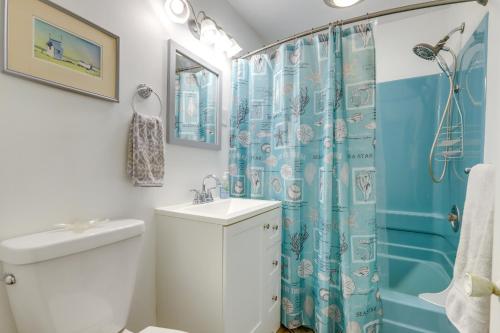 uma casa de banho com uma cortina de chuveiro azul e um lavatório. em Worcester Home on Indian Lake with Shared Boat Dock! em Worcester