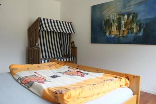 a bed in a room with a painting on the wall at modern eingerichtete Ferienwohnung in Andermatt - b48523 in Andermatt