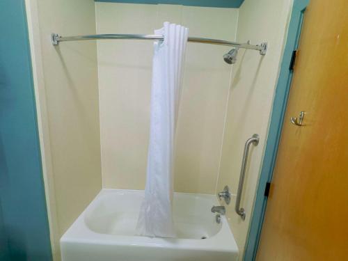 a shower with a white shower curtain in a bathroom at Best Western Plus Glen Allen Inn in Richmond