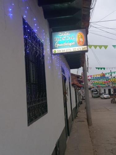 um sinal para uma farmácia do lado de um edifício em CASA HOSTAL GUADALUPE em Guadalupe