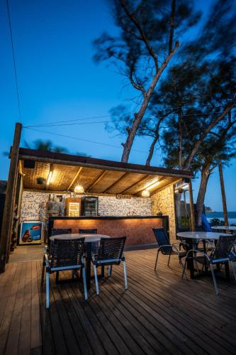 a deck with a table and chairs on it at Pousada dos Gravatás in Búzios