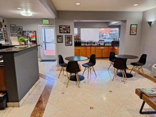 a restaurant with two tables and chairs in a room at Portofino Inn Burbank in Burbank