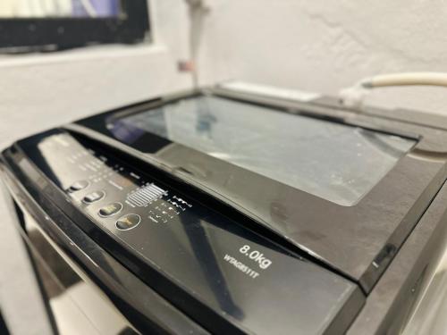 a close up of a toaster oven with a glass top at New 2BR or 3BR Homey Getaway stay 7 to 10 pax at Urban Suites, Georgetown by URBAN STAYCATION LOD in Jelutong