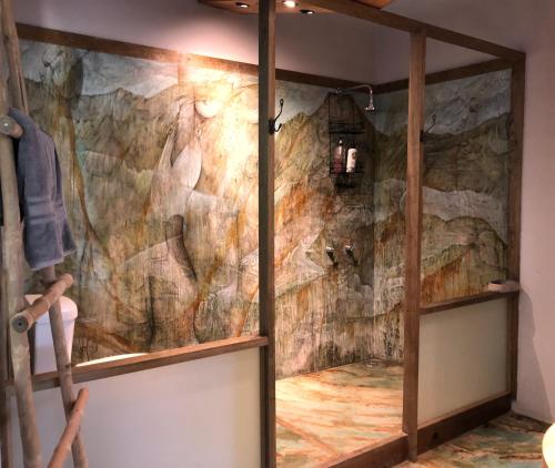 a bathroom with a stone wall at Frondavista San Pancho in San Francisco