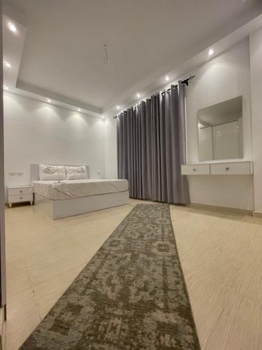 a bedroom with a bed and a rug on the floor at Apartments in Florenza Khamsin in Hurghada