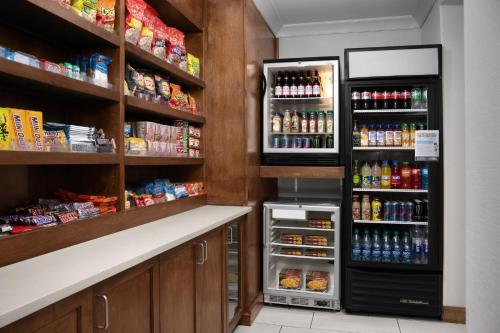 a grocery store aisle with a refrigerator at Holiday Inn Express & Suites Alexandria - Fort Belvoir, an IHG Hotel in Alexandria