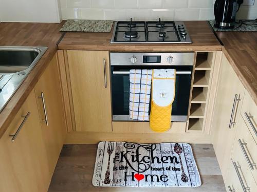 a kitchen with a stove and a mat on the floor at Your Staycation in Bristol