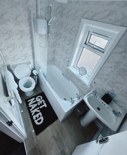 a bathroom with a tub and a sink and a toilet at Your Staycation in Bristol