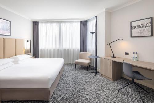 a hotel room with a bed and a desk at Crowne Plaza Milan Linate by IHG in San Donato Milanese