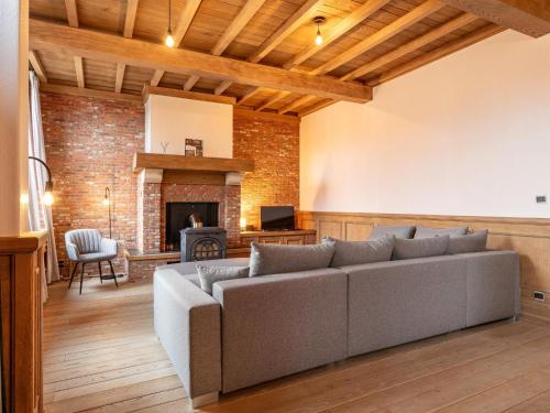 a living room with a couch and a fireplace at De Marckhoeve in Merksplas