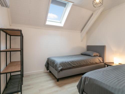 a bedroom with a bed and a window at De Marckhoeve in Merksplas