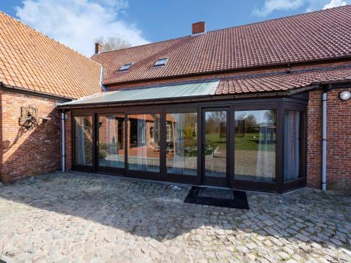 an extension to a house with glass doors at De Marckhoeve in Merksplas