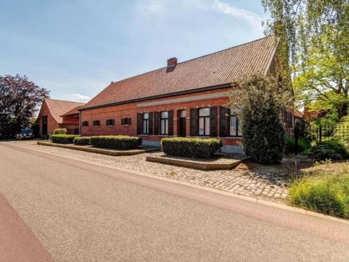 a red brick house on the side of a street at De Marckhoeve in Merksplas