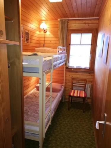 a small room with two bunk beds in a cabin at Chalet Oase Obere Wohnung - b48609 in Susten