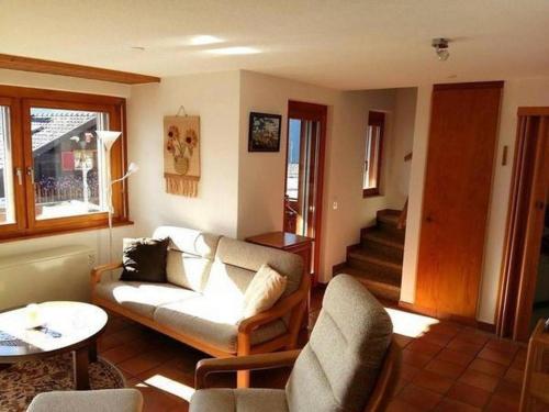 a living room with a couch and a table at Chalet Angelika - b48583 in Albinen