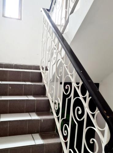 a set of stairs with a wrought iron railing at Habitación Mar in Veracruz