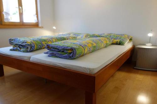 a bed with two pillows on top of it at Chamonix 2-Bettwohnung - b48634 in Grindelwald