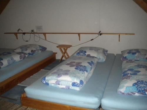 two beds sitting in a room with at "Hüttli" neben dem Bauernhof Fendrig - b48572 in Haslen