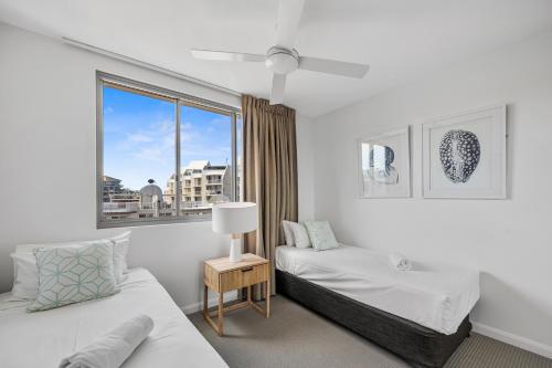 a bedroom with two beds and a window at Nova Mooloolaba Beach Apartments in Mooloolaba