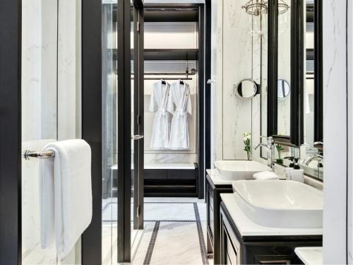 a bathroom with two sinks and two mirrors at InterContinental Chiang Mai The Mae Ping in Chiang Mai