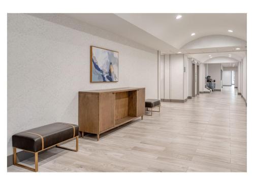 a hallway with a desk and benches in a building at Staybridge Suites Federal Way - Seattle South by IHG in Federal Way
