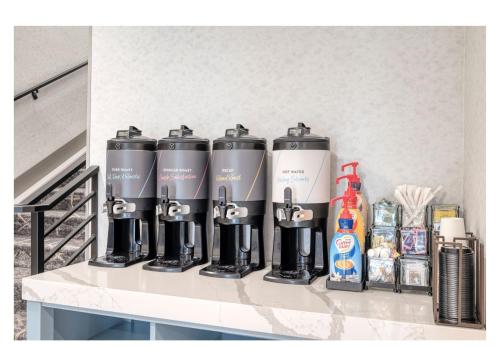 a group of four energy bottles on a counter at Staybridge Suites Federal Way - Seattle South by IHG in Federal Way