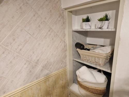 a walk in closet with towels and baskets at Futura House 2 Bagheria in Bagheria