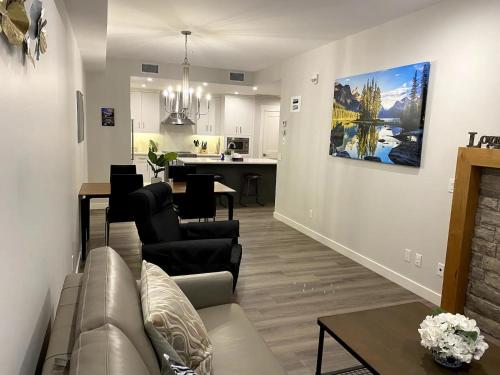 a living room with a couch and a dining room at Luxury unit in the heart of Canmore in Canmore