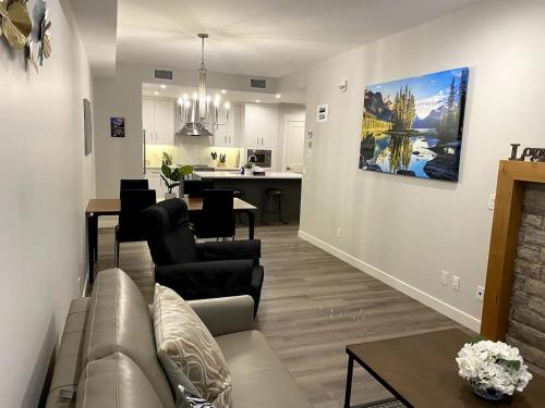 a living room with a couch and a dining room at Luxury unit in the heart of Canmore in Canmore