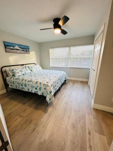 a bedroom with a bed and a ceiling fan at Sea Turtle Cove in Clearwater