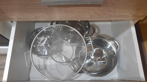 a bunch of plates and other dishes in a drawer at Mieszkanie osiedle Północ Zameldowanie 24h in Koszalin
