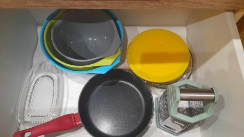a toy kitchen with bowls and utensils in a drawer at Mieszkanie osiedle Północ Zameldowanie 24h in Koszalin