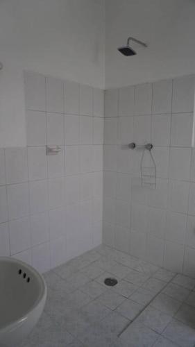 a white bathroom with a sink and a toilet at Alberto departamento en centro Histórico Oaxaca in Oaxaca City