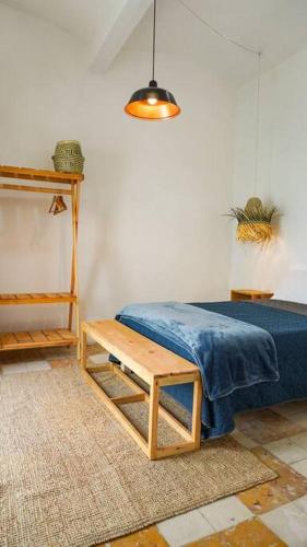 a bedroom with a blue bed and a table at Alberto departamento en centro Histórico Oaxaca in Oaxaca City